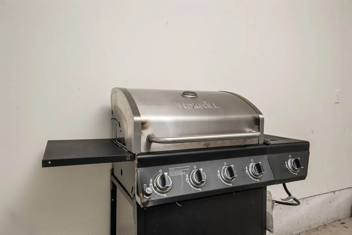 A modern grill setup, primed for outdoor cooking, hinting at a welcoming patio or terrace space where guests can dine al fresco and enjoy the sunset views across the lake.