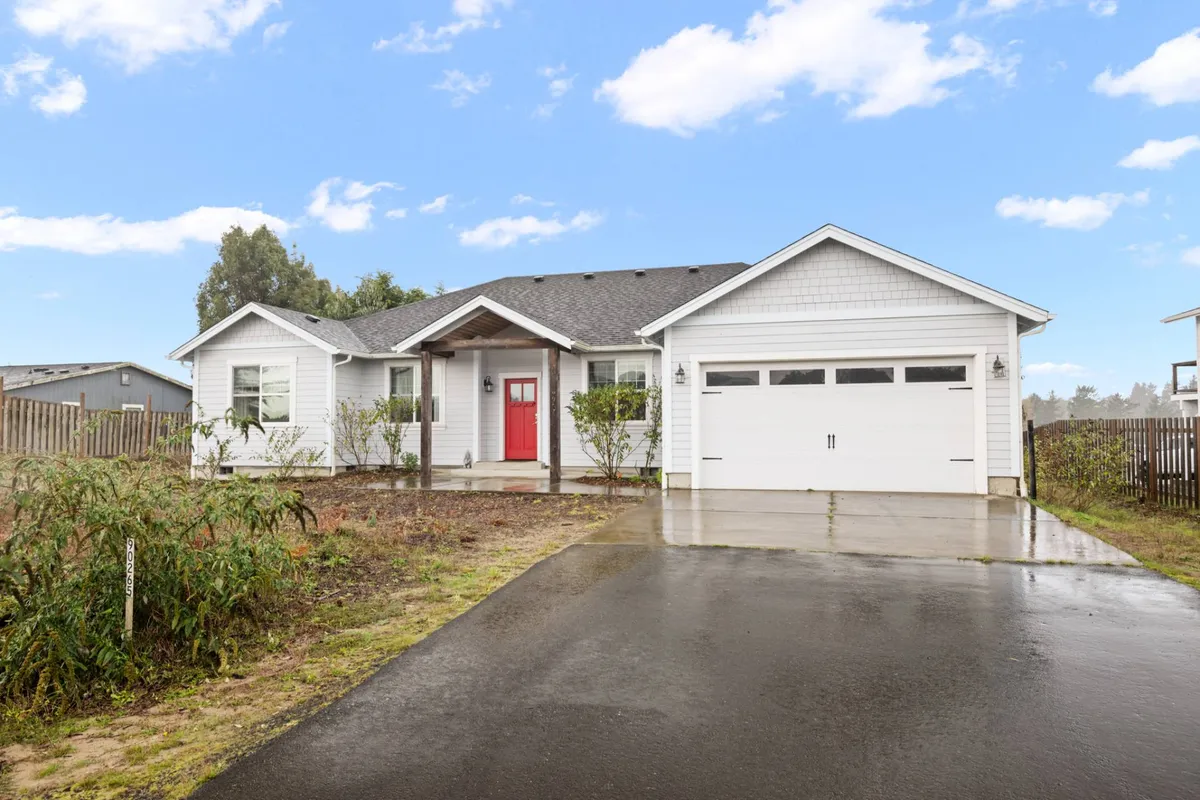 The welcoming exterior of a home with a bright red front door, landscaped front yard, and ample space for outdoor activities. The setting suggests a friendly, family-oriented environment and is visually linked to the idea of coming home after a day of adventure.